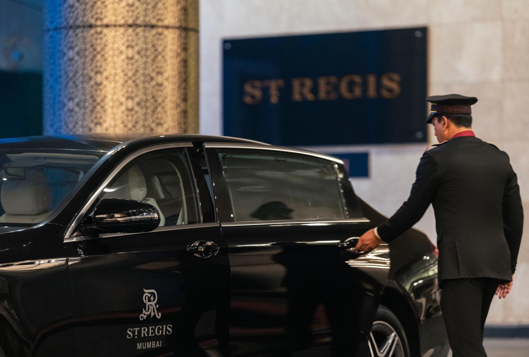 The St. Regis Mumbai Hotel Kültér fotó A chauffeur opening the door of a car